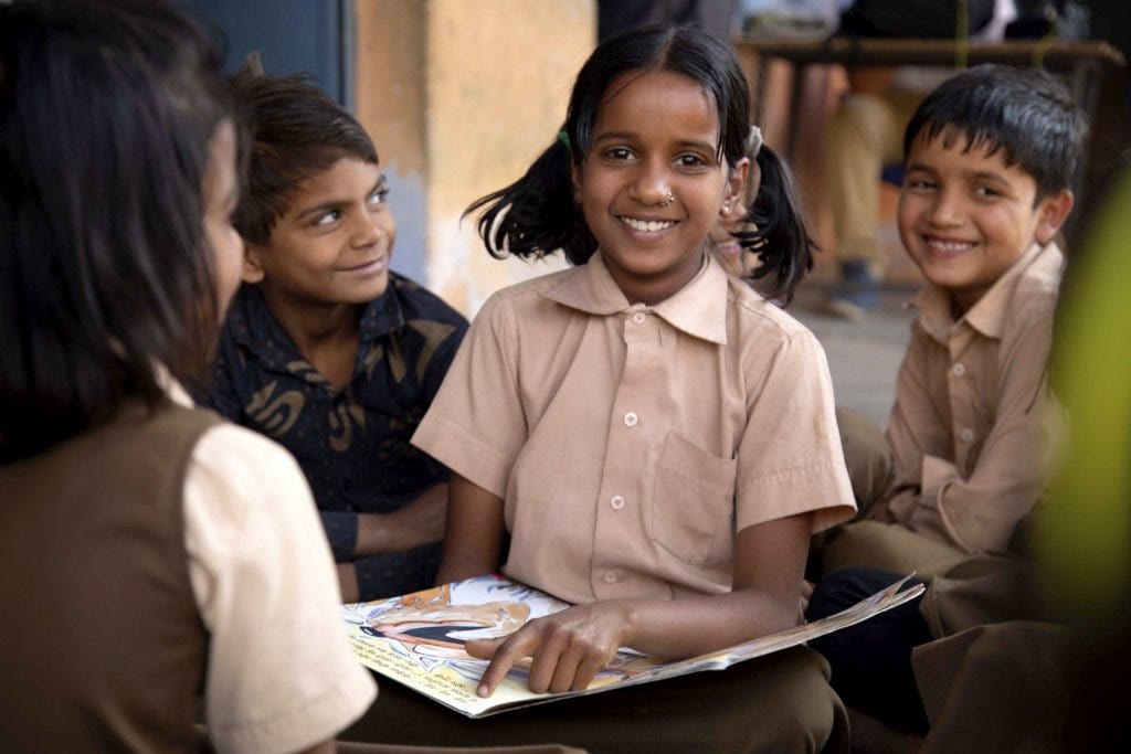 School children reading educational books together supported by Lilvex Group